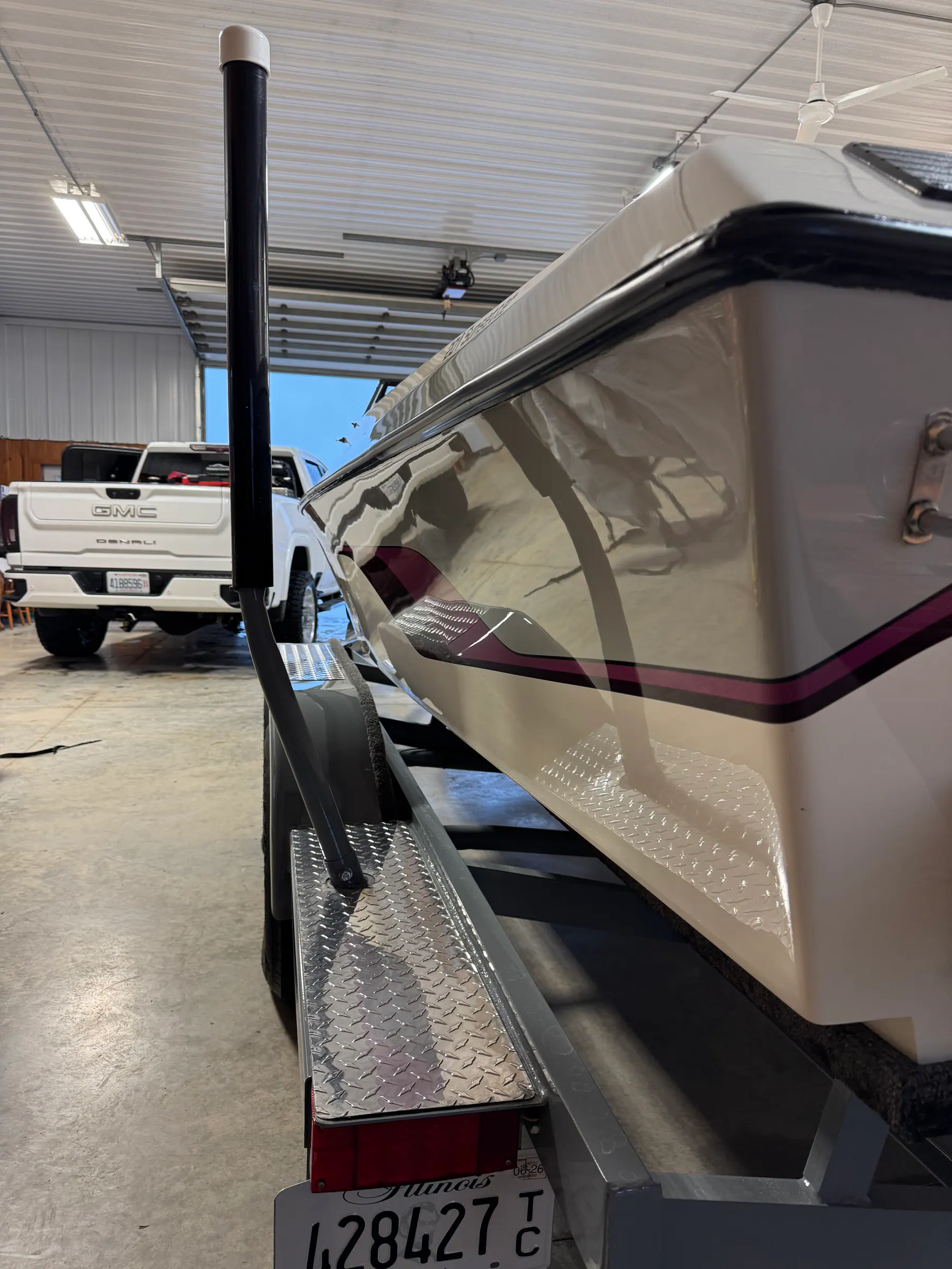 Glossy white and burgundy boat finish inside the Premier Coatings shop